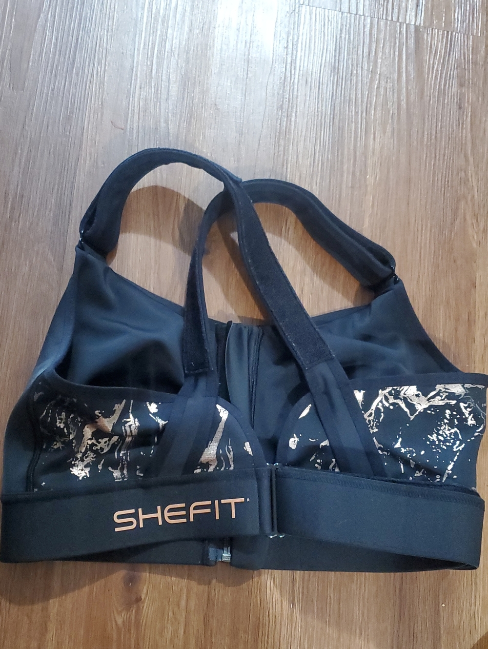SHEFIT Black Sports Bra with Metallic Gold Accents